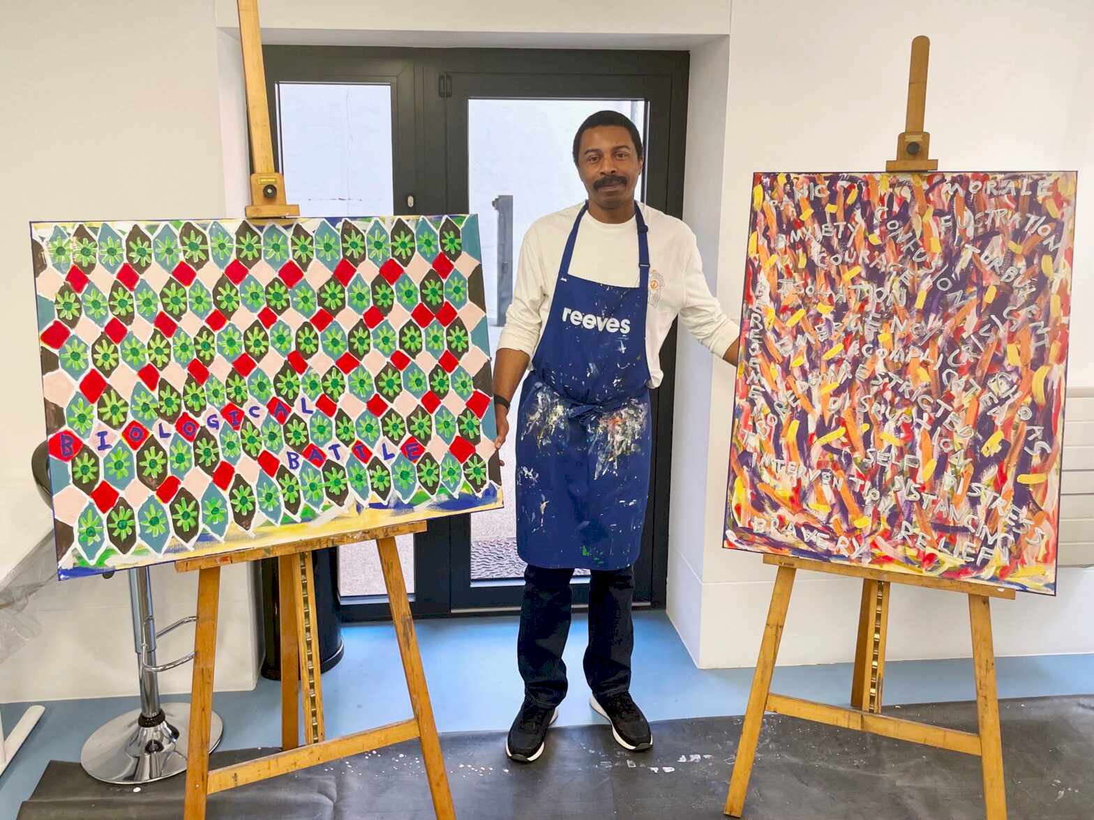 Artist Thompson Hall with two of his artworks