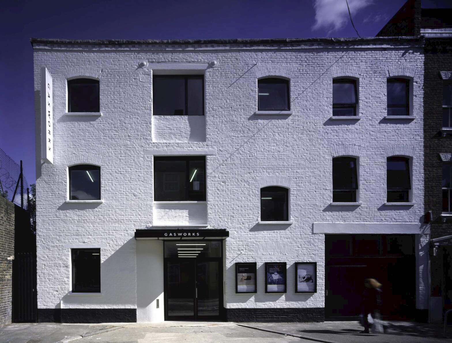 Gasworks Exterior, a 3 floor warehouse building converted for use as an art gallery and creative spaces, painted white.